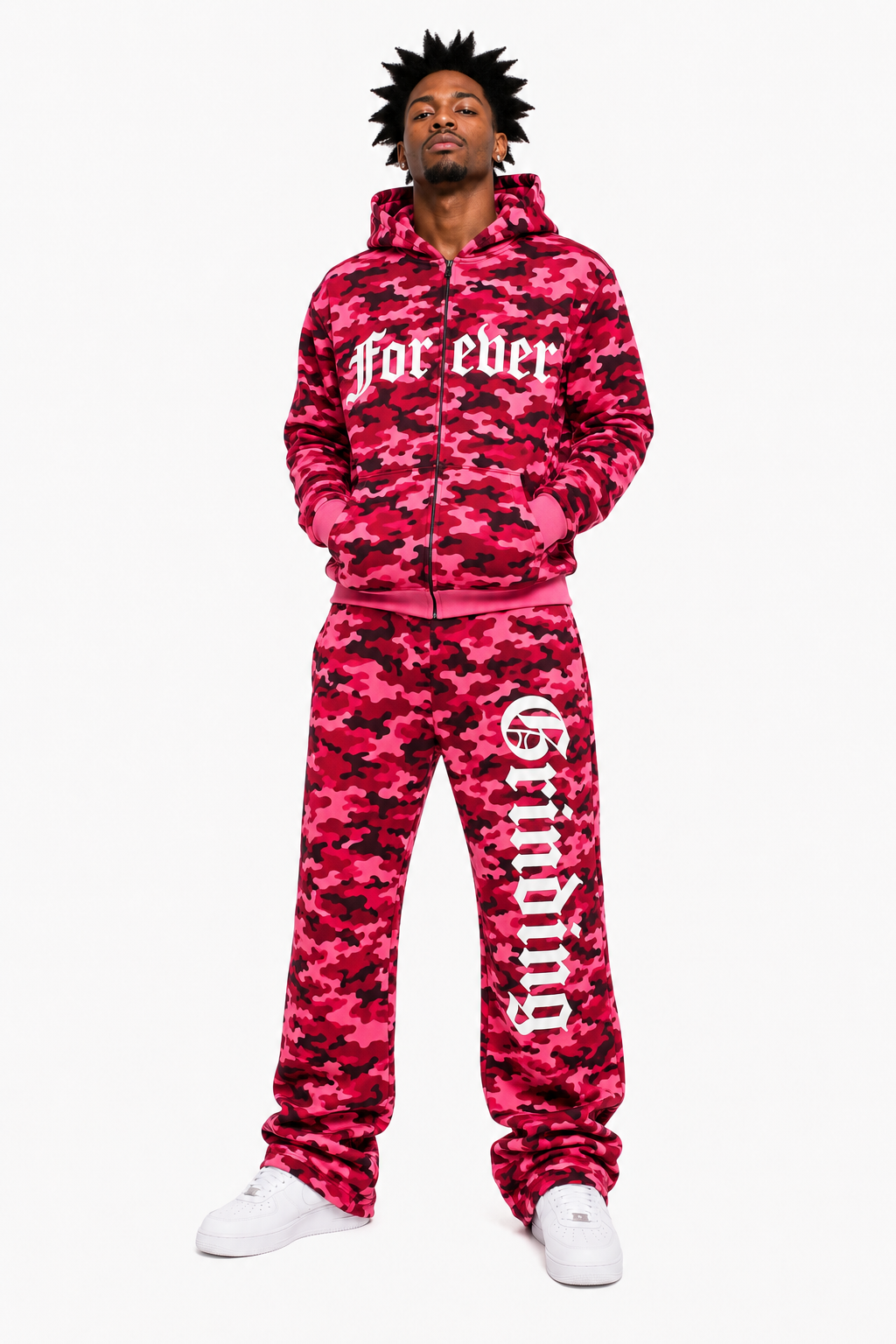 Person wearing a pink camouflage tracksuit with text on a white background