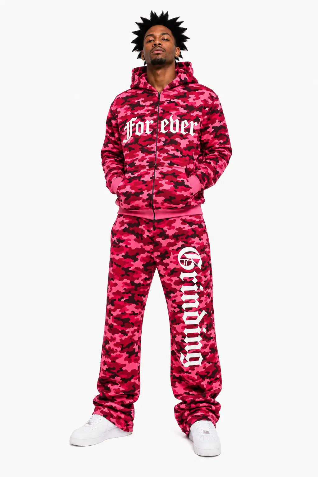 Person wearing a pink camouflage tracksuit with text on a white background
