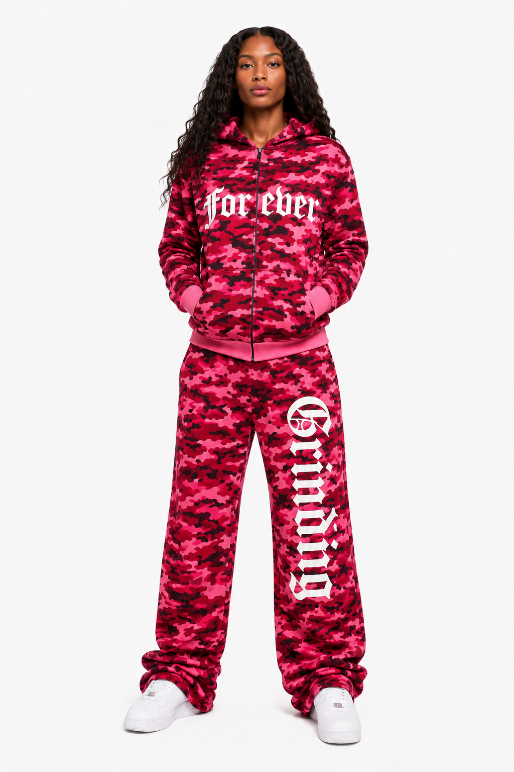 Person wearing a pink camouflage tracksuit with text on a white background