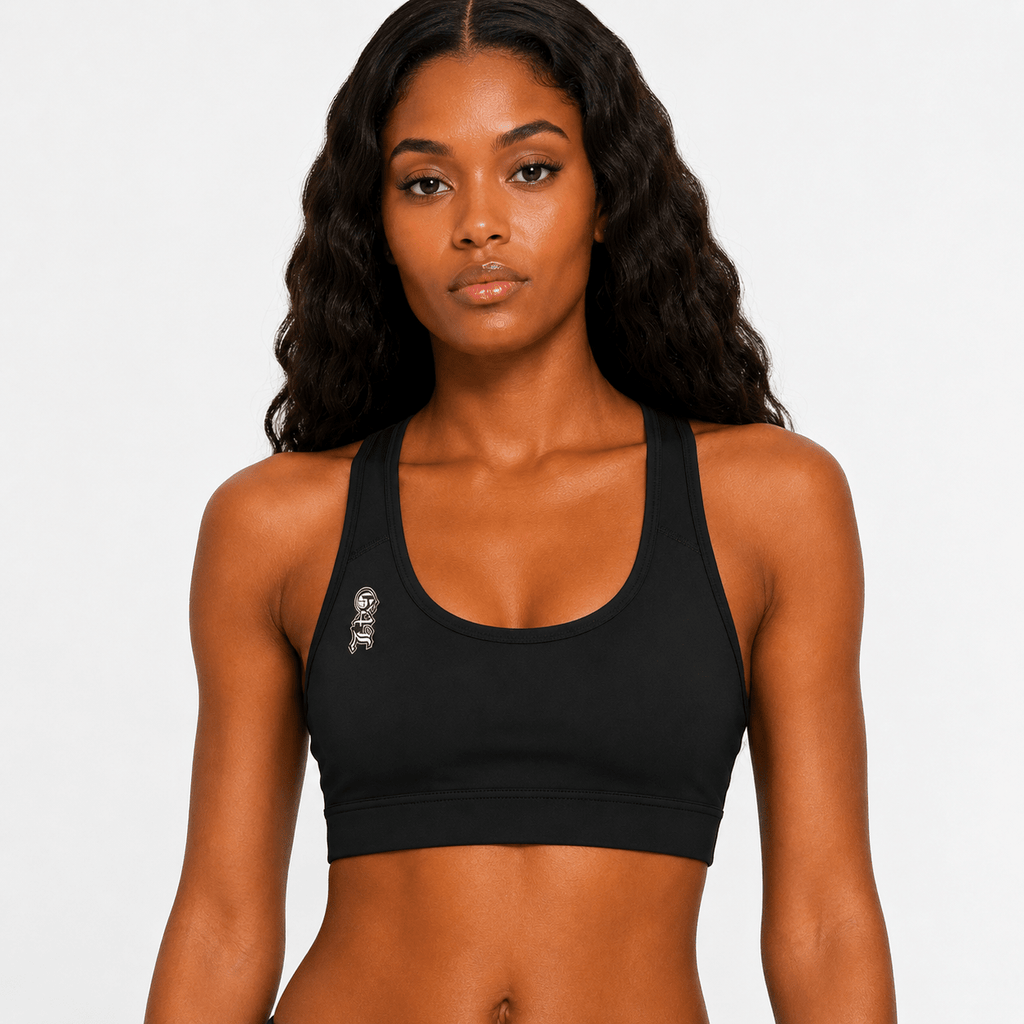 Woman wearing a black sports bra against a plain background