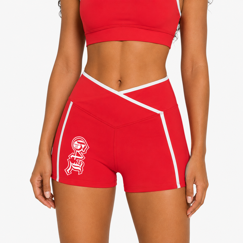 Red athletic shorts with white accents and a logo on a plain background