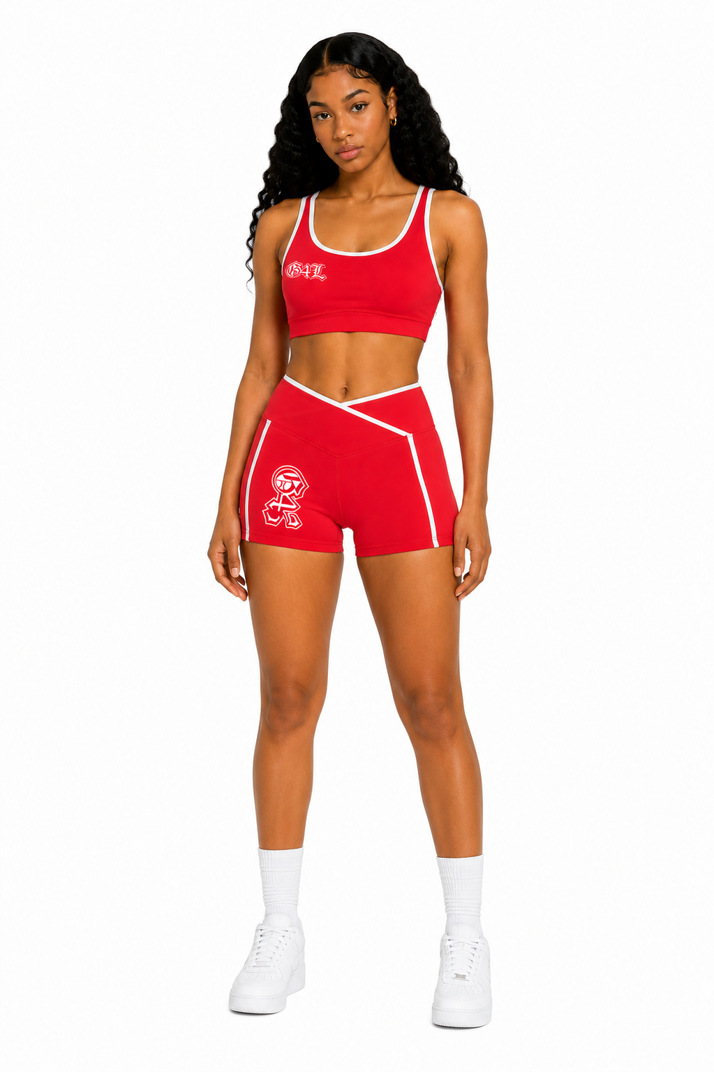 Woman wearing a red sports bra and shorts set on a white background
