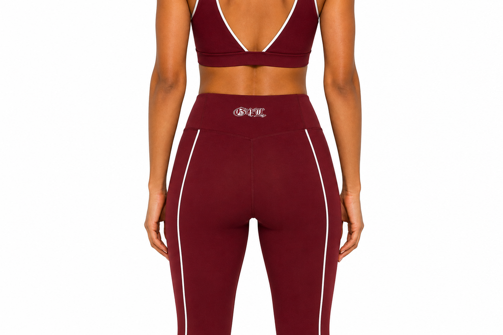 Maroon sports bra and leggings with a logo on a white background
