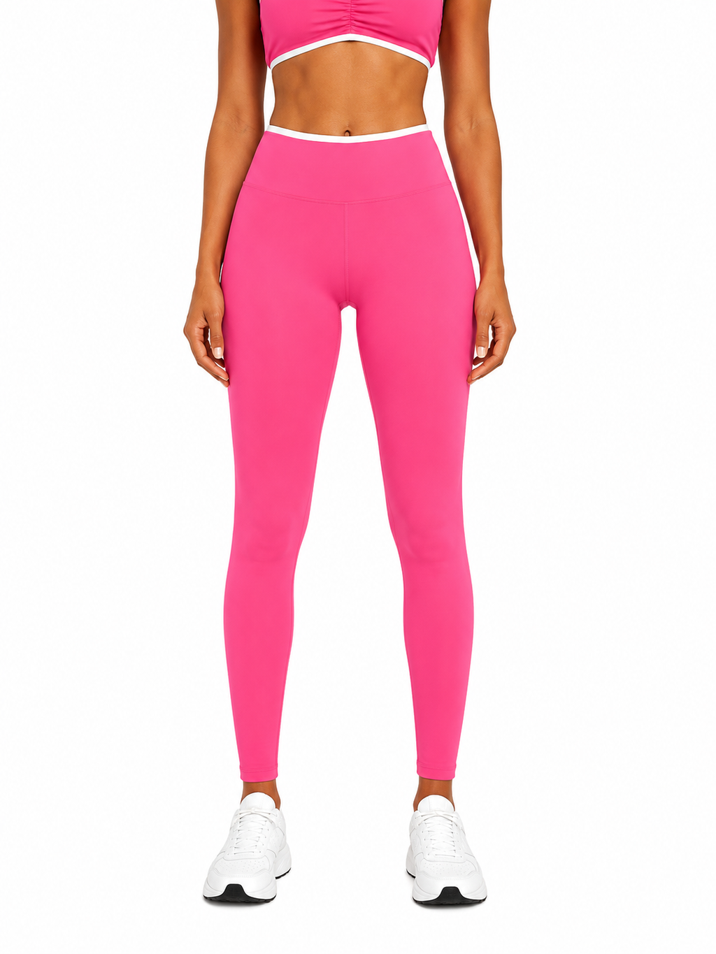 Person wearing bright pink leggings and a matching top on a white background