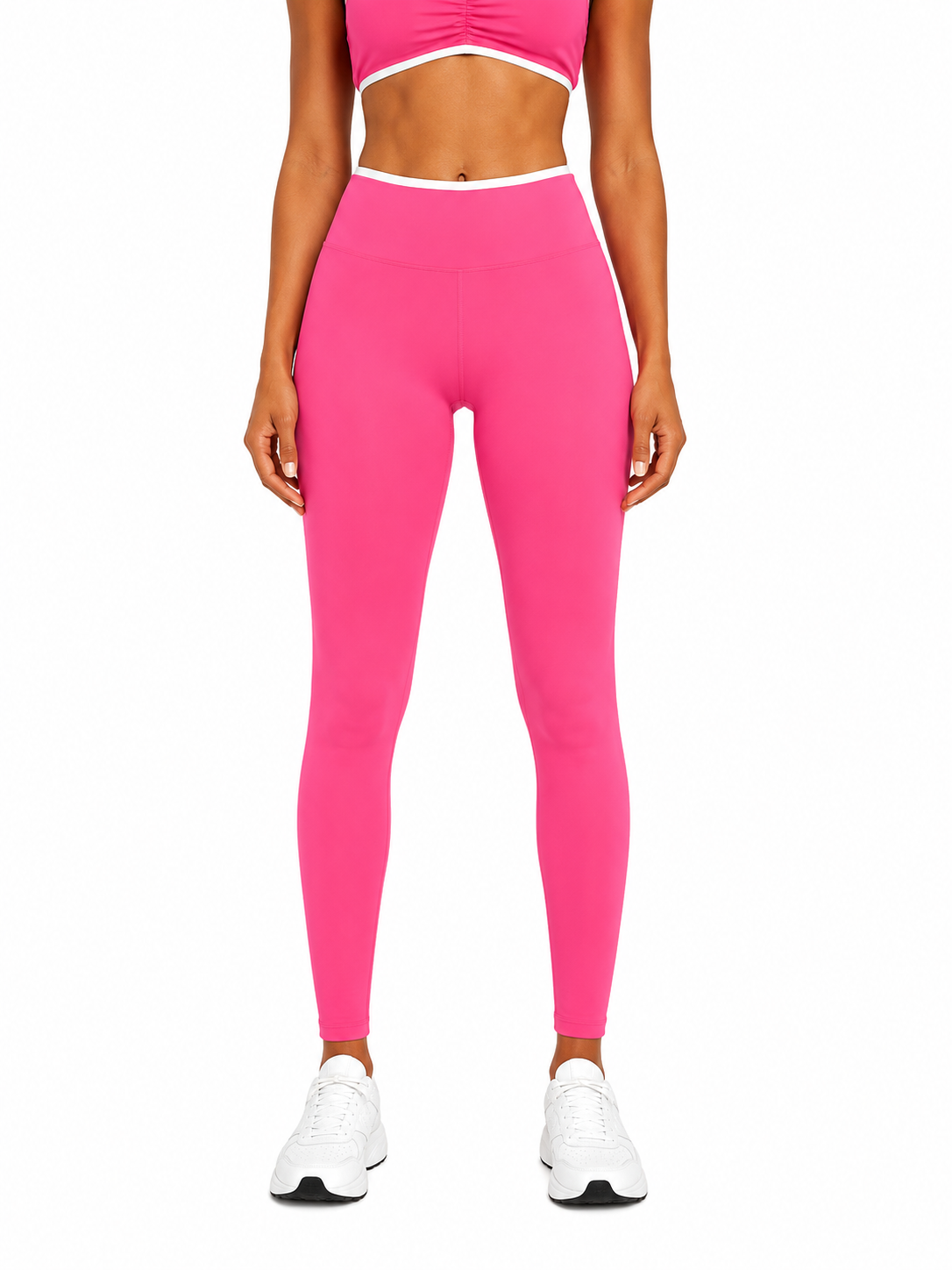 Person wearing bright pink leggings and a matching top on a white background