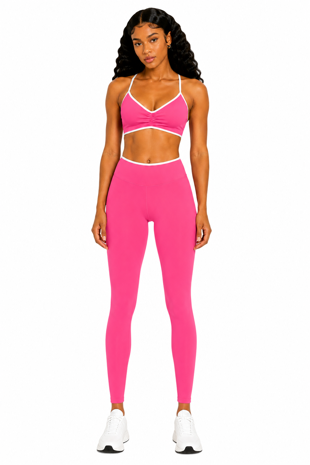 Woman wearing a pink sports bra and leggings set on a white background