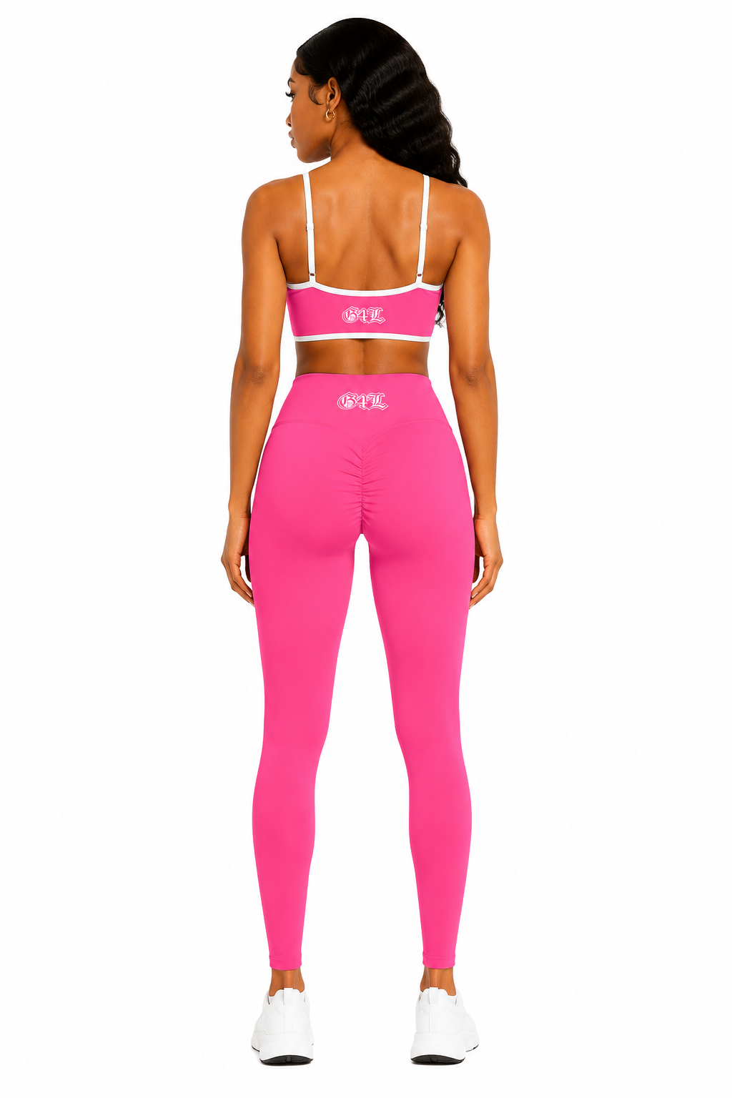 Person wearing a pink sports bra and leggings set on a white background