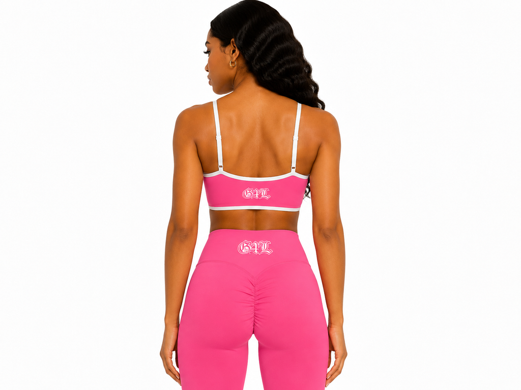 Woman wearing a pink sports bra and leggings with a brand logo on a white background