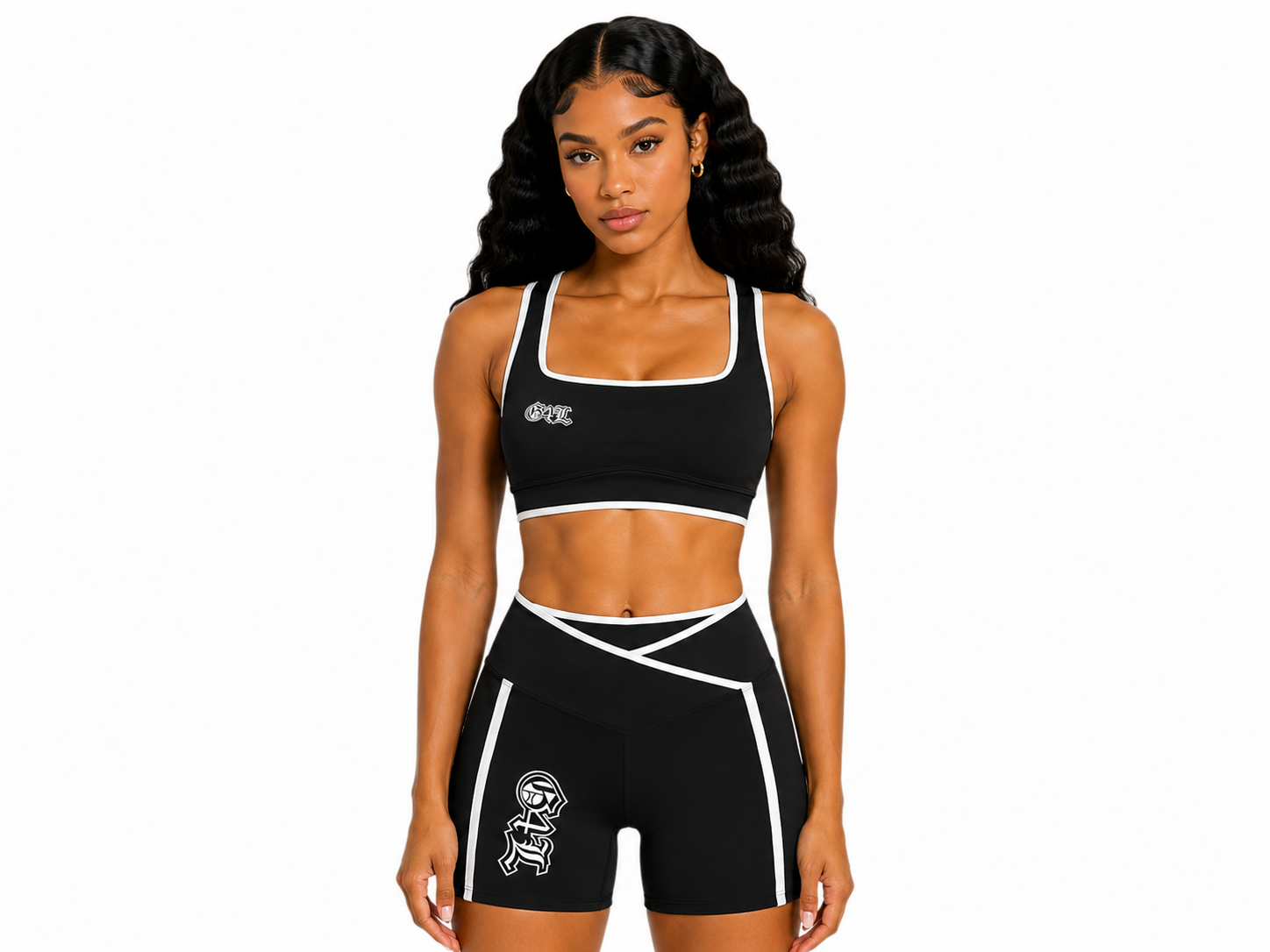 Woman wearing a black sports bra and shorts with a logo on a white background