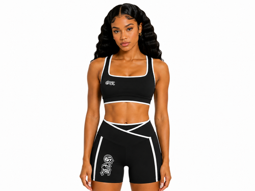 Woman wearing a black sports bra and shorts with a logo on a white background