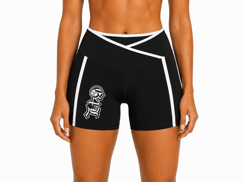Person wearing a black sports bra and shorts on a white background