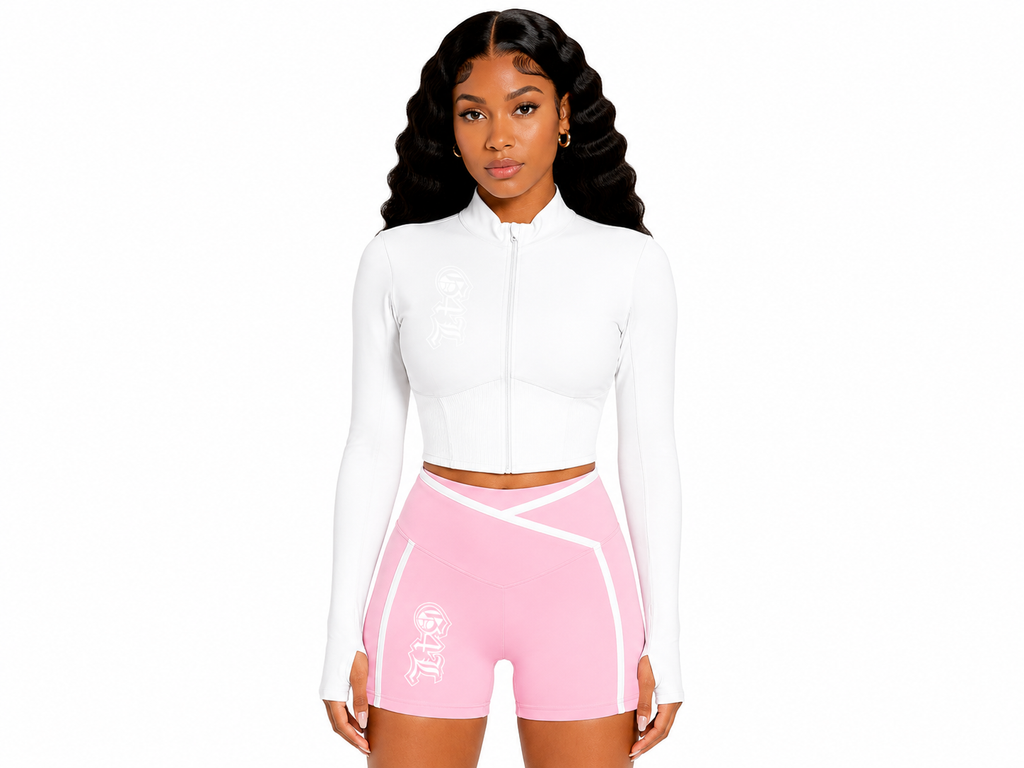 Woman wearing a white long-sleeve top and pink athletic shorts on a white background