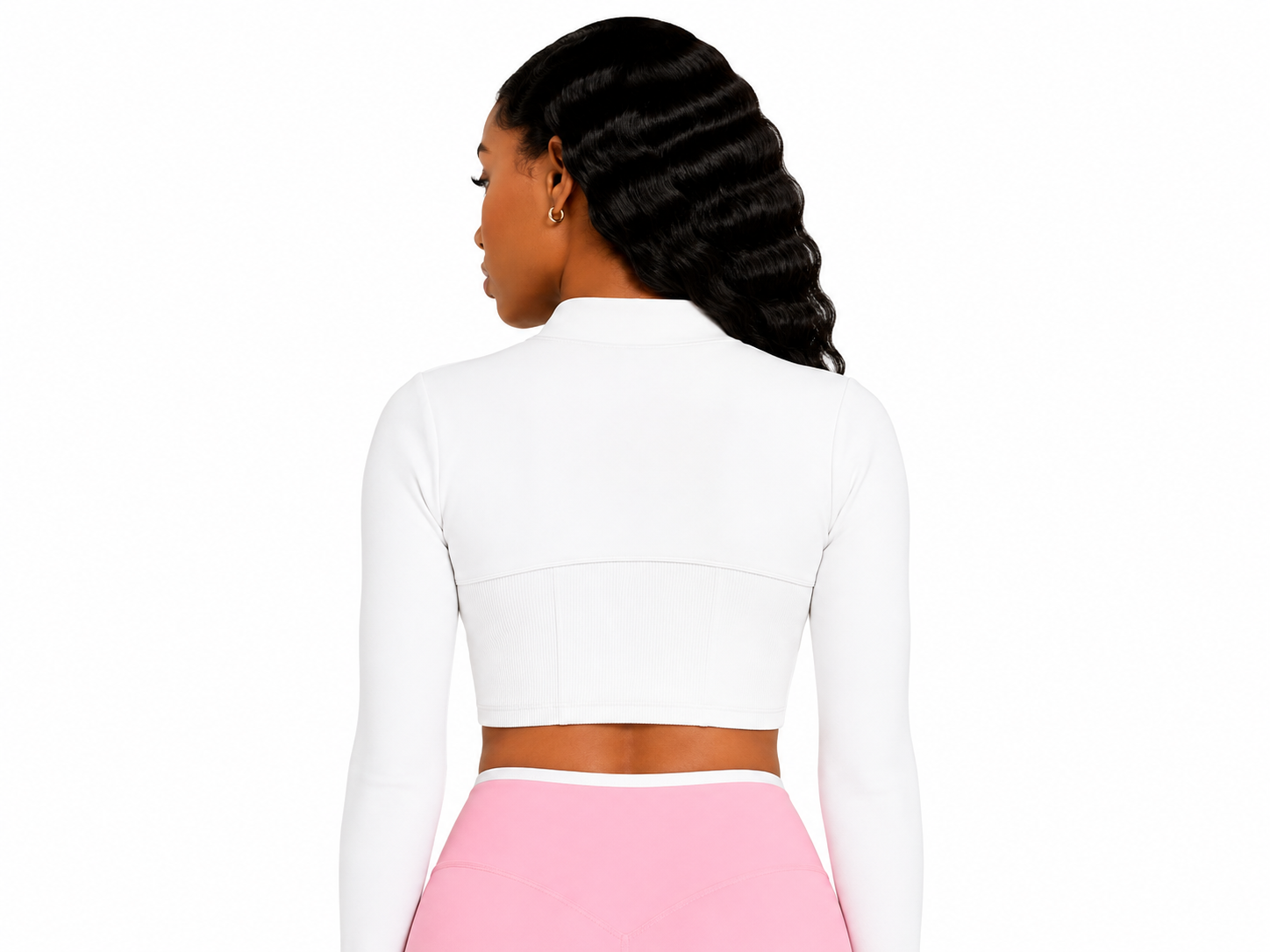Woman wearing a white long-sleeve top and pink skirt on a white background