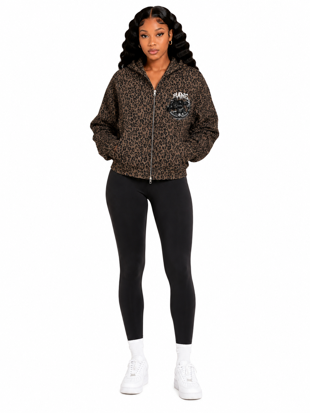 Woman wearing a leopard print hoodie and black leggings on a white background