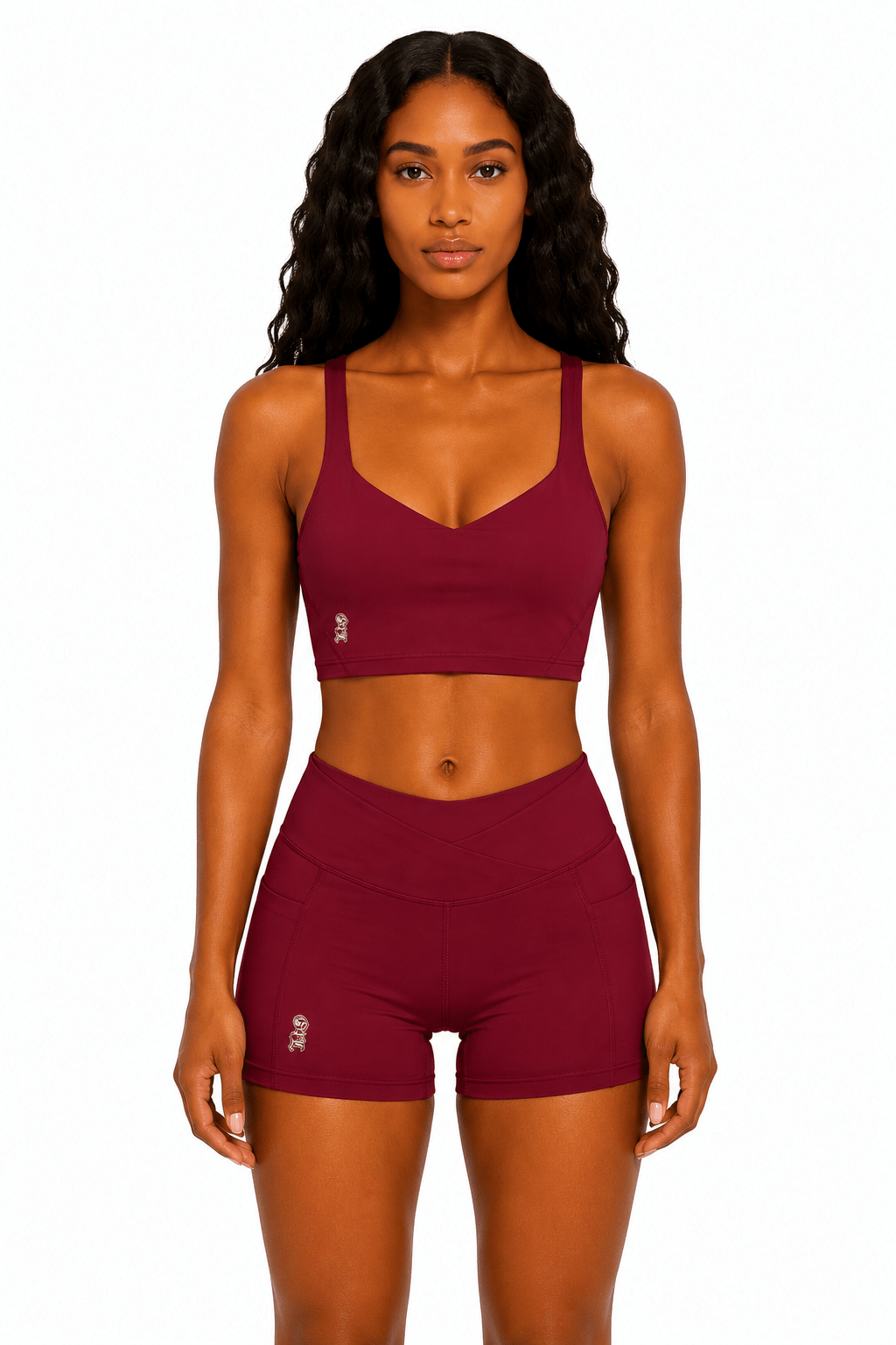 Woman wearing a maroon sports bra and shorts set on a white background