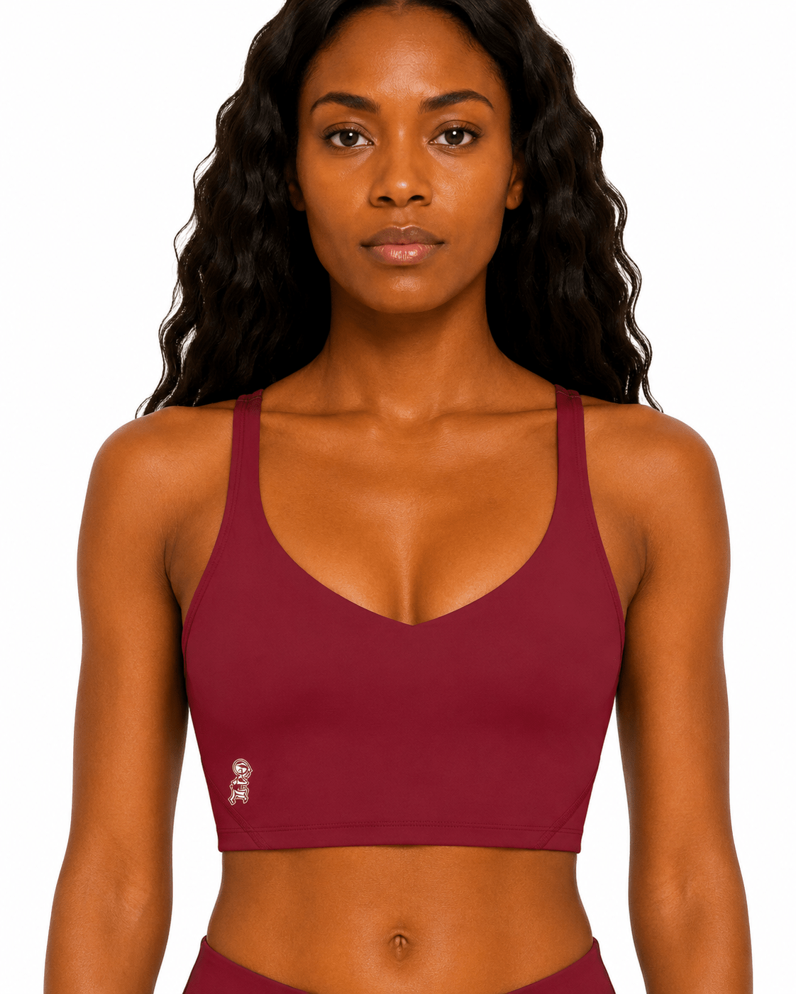 Woman wearing a maroon sports bra on a white background