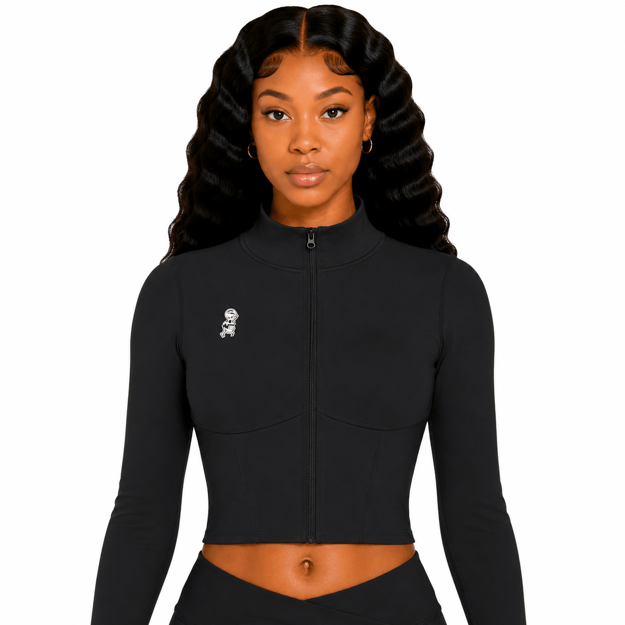 Woman wearing a black long-sleeve crop top with a small white logo on a white background