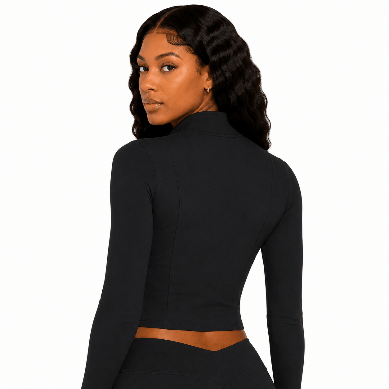Woman wearing a black long-sleeve crop top on a white background