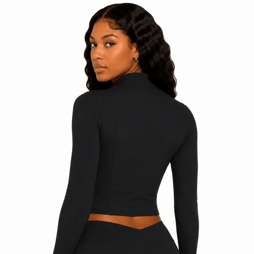 Woman wearing a black long-sleeve crop top on a white background
