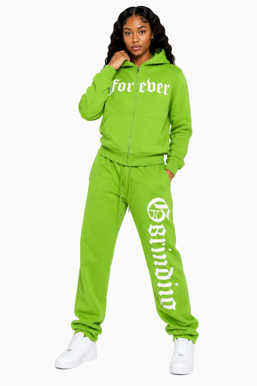 Woman wearing a bright green tracksuit with text on a white background