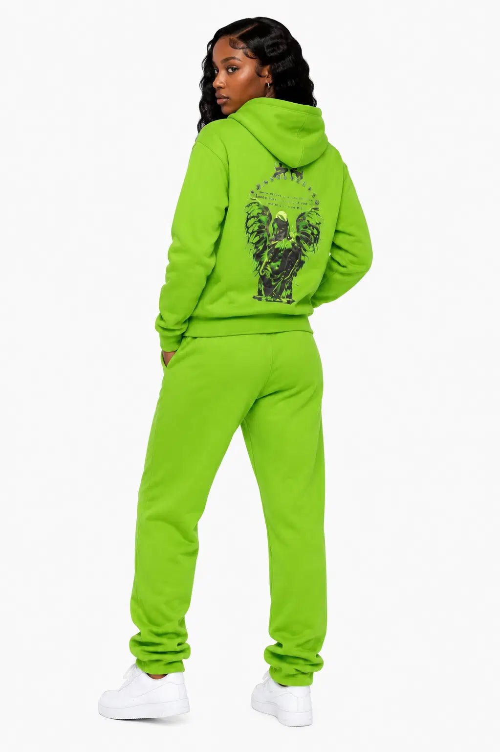 Person wearing a bright green tracksuit with a design on the back against a white background