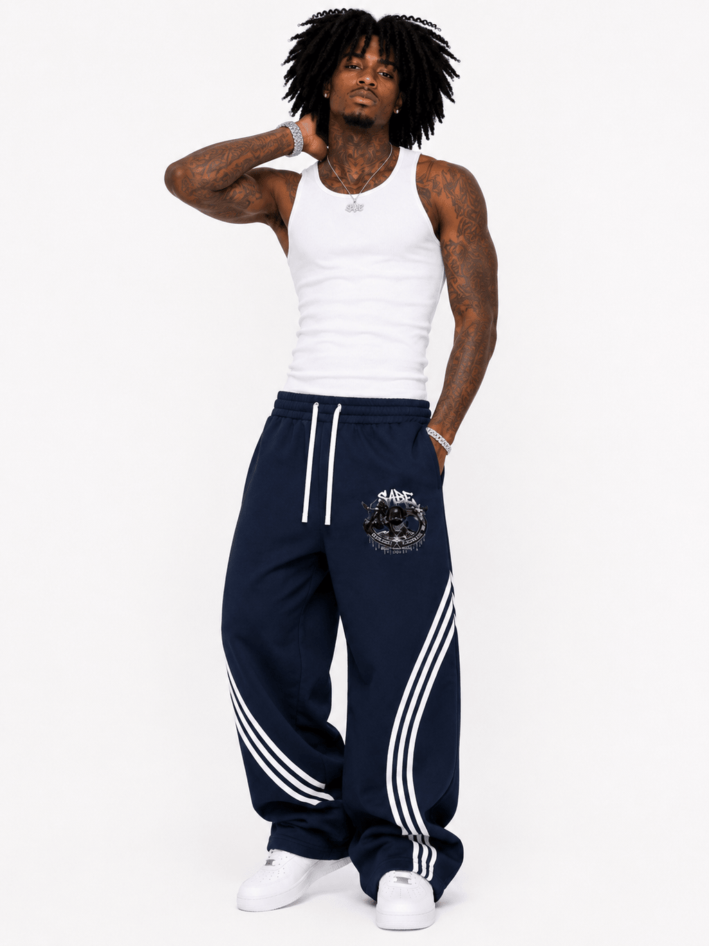 Person wearing navy tracksuit with white stripes on a white background