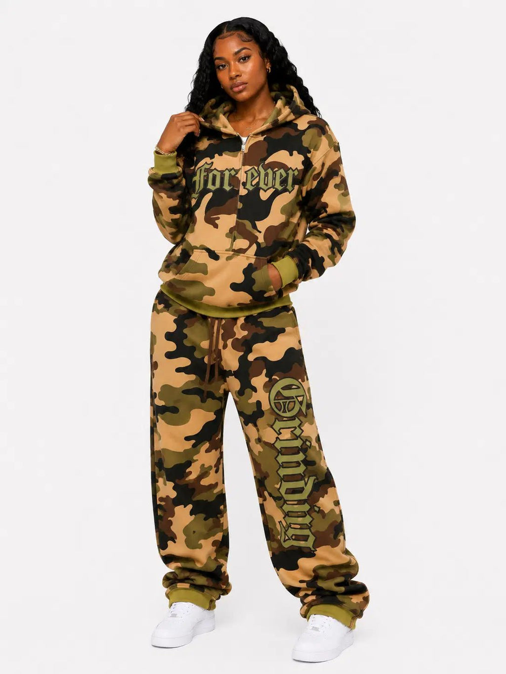 Person wearing a camouflage tracksuit with 'for ever' text on a white background