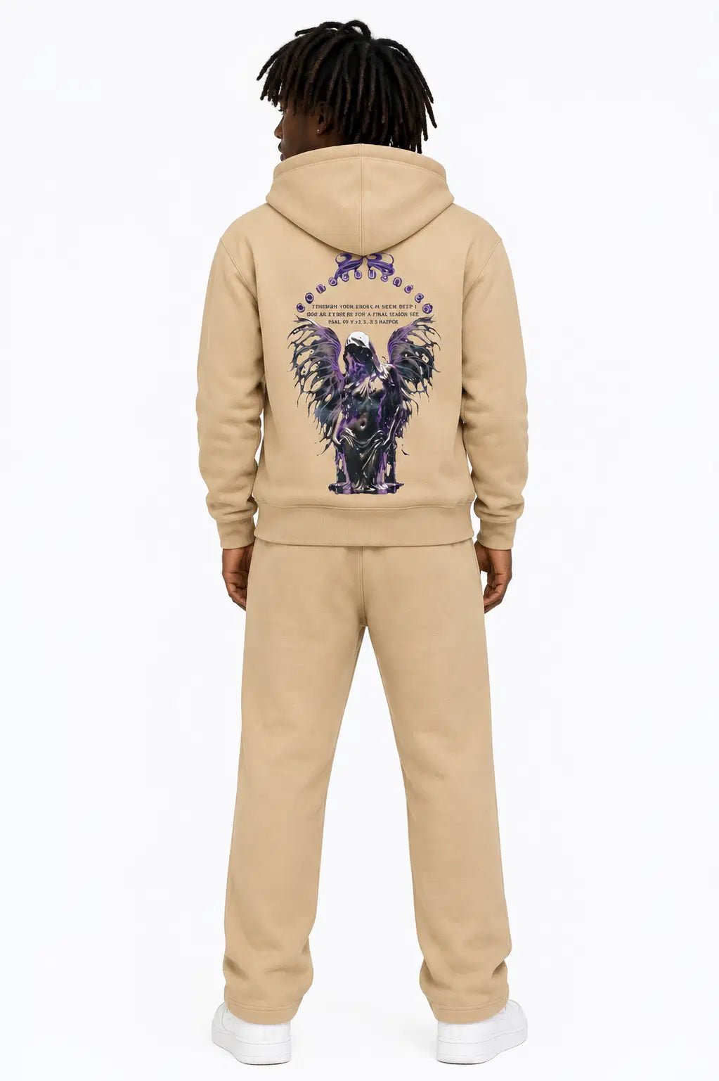 Person wearing a beige tracksuit with a colorful eagle design on the back, standing against a white background.