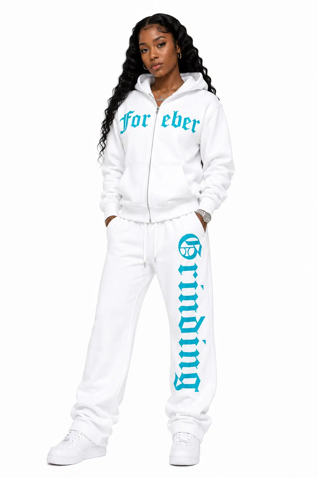 White tracksuit with turquoise text worn by a model on a white background