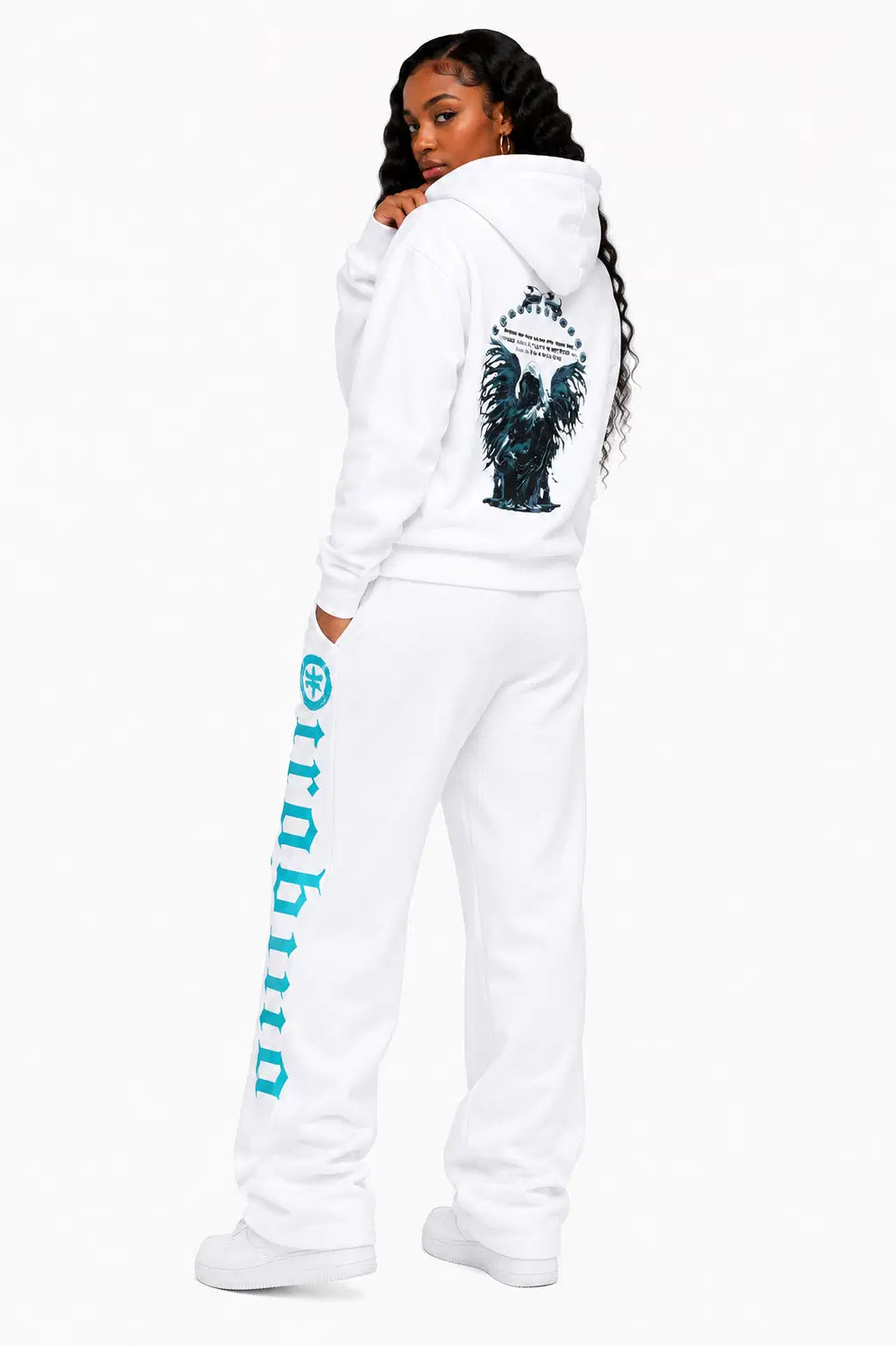 Person wearing a white hoodie and pants with a brand logo on a white background