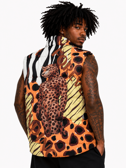 Person wearing a sleeveless shirt with a leopard print design on a plain background