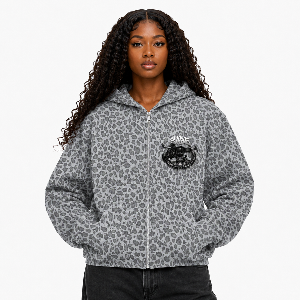 Person wearing a gray leopard print hoodie with a brand logo on a white background