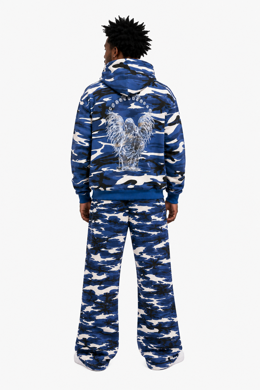 Person wearing a blue and white camouflage hoodie and pants on a white background