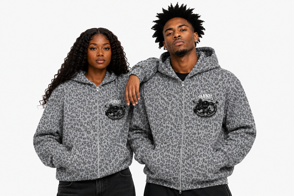Two people wearing gray patterned hoodies with logos on a white background