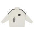 An off-white zip-up track jacket with black double stripes on the shoulders, a black graphic on the left chest, and vertical black script text on the right chest, displayed flat against a white background.