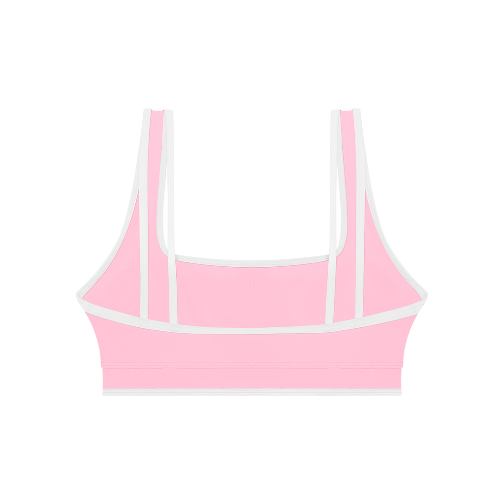 Pink sports bra with thin straps on a white background