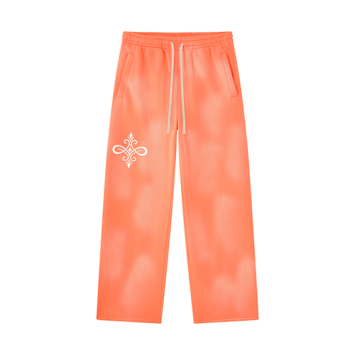 Bright orange tie-dye sweatpants with a white drawstring and a white decorative emblem on the left thigh, shown against a plain white background.