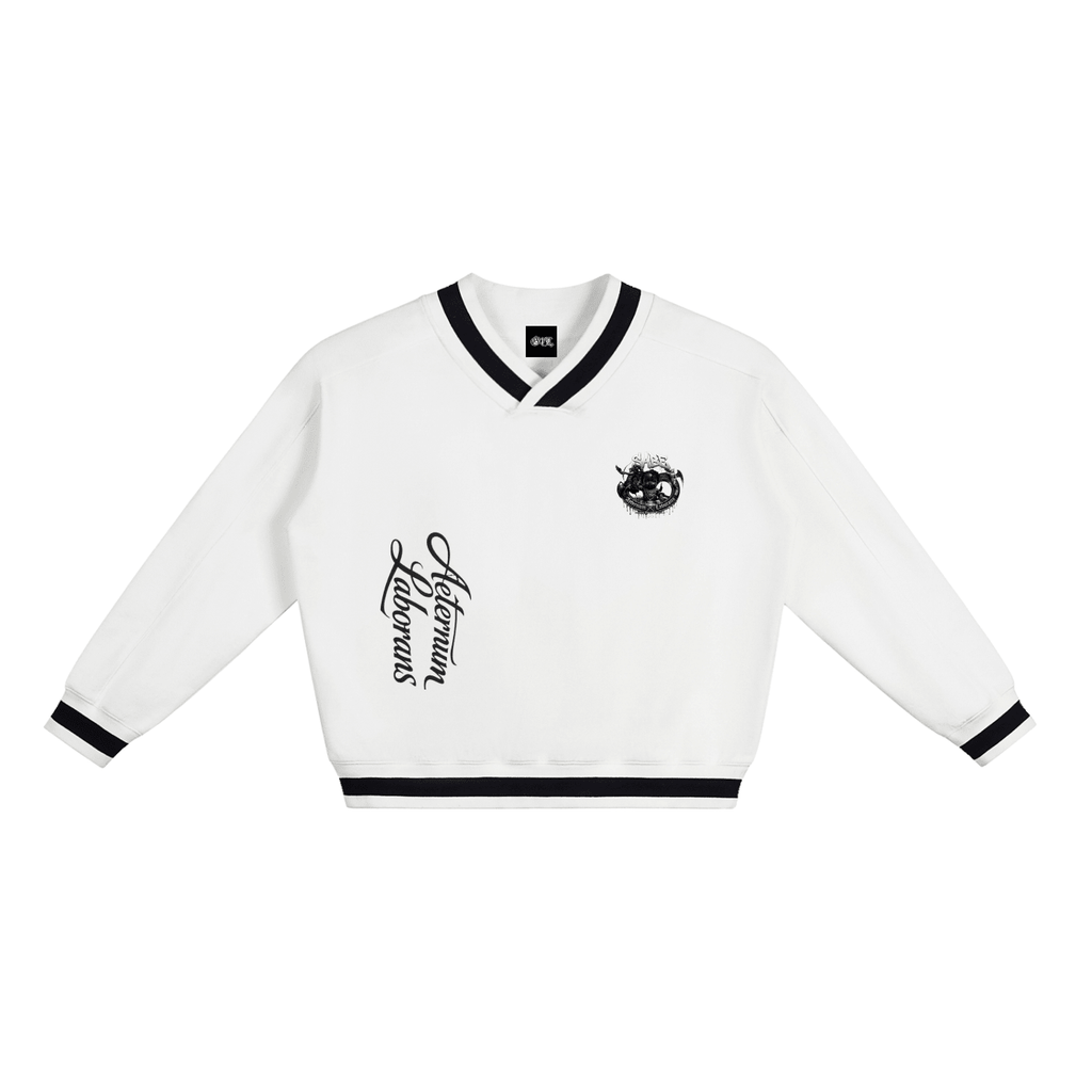 A white long-sleeve cropped sweater with black trim on the V-neck collar, cuffs, and hem, featuring a black script graphic on the right chest and a small crest graphic on the left chest.