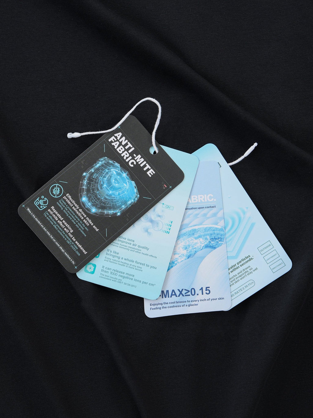 Anti-mite fabric tags on a black fabric background